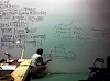 lecture performance by Goodiepal with notes written on the wall.